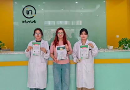 Three Intertek China colleagues hold up their donation certificates. 