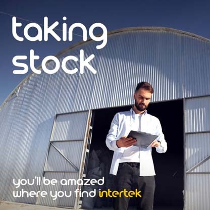 A man looking at a tablet while leaving a storage shed